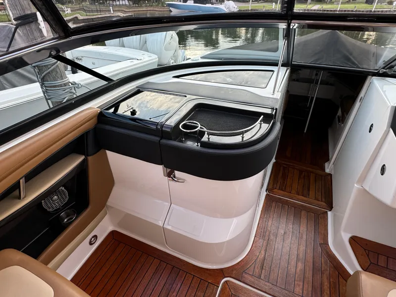 Slide: The Image of Interior of 2015 Sea Ray 350 SLX boat with wood flooring and sleek design. - 24