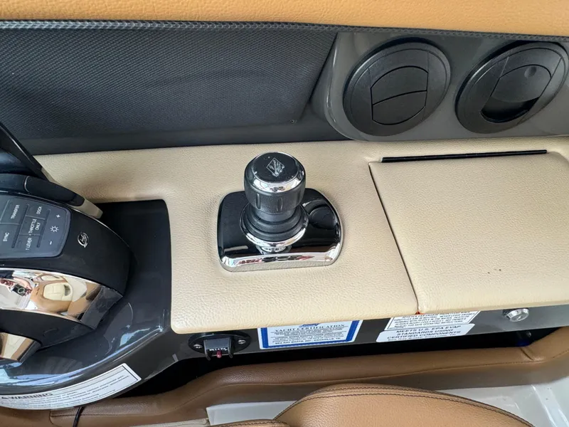 Slide: The Image of 2015 Sea Ray 350 SLX boat control panel with joystick and switches. - 45