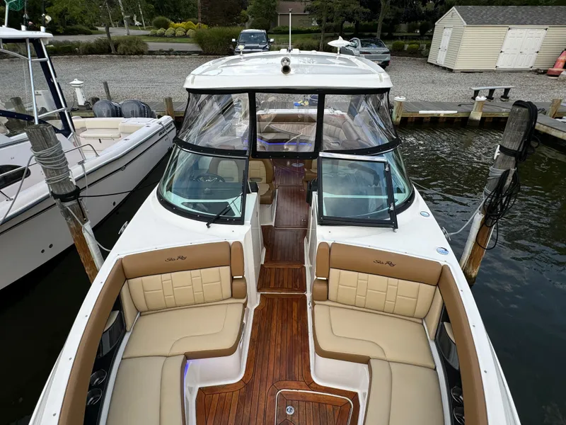 Slide: The Image of 2015 Sea Ray 350 SLX boat with spacious seating and sleek design at dock. - 25