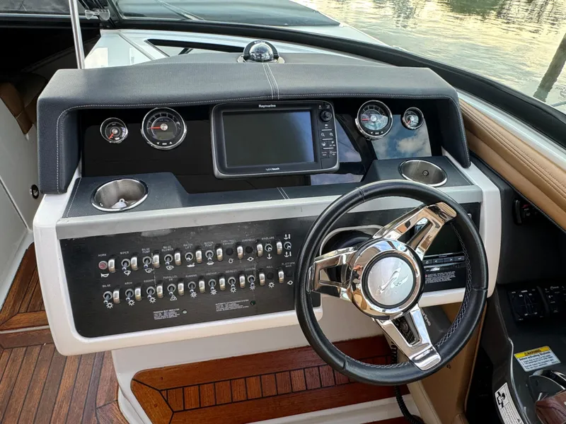 Slide: The Image of 2015 Sea Ray 350 SLX helm with steering wheel, gauges, and navigation system. - 39