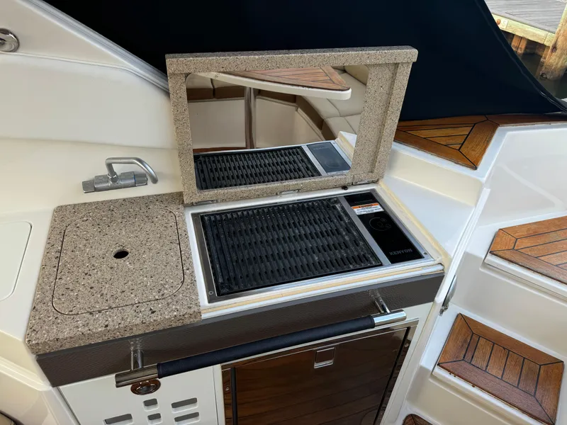 Slide: The Image of 2015 Sea Ray 350 SLX boat interior with grill and countertop. - 14