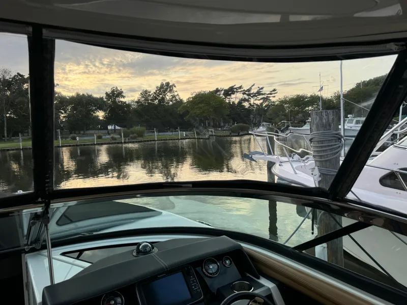 Slide: The Image of View from 2015 Sea Ray 350 SLX boat cockpit at serene marina. - 20