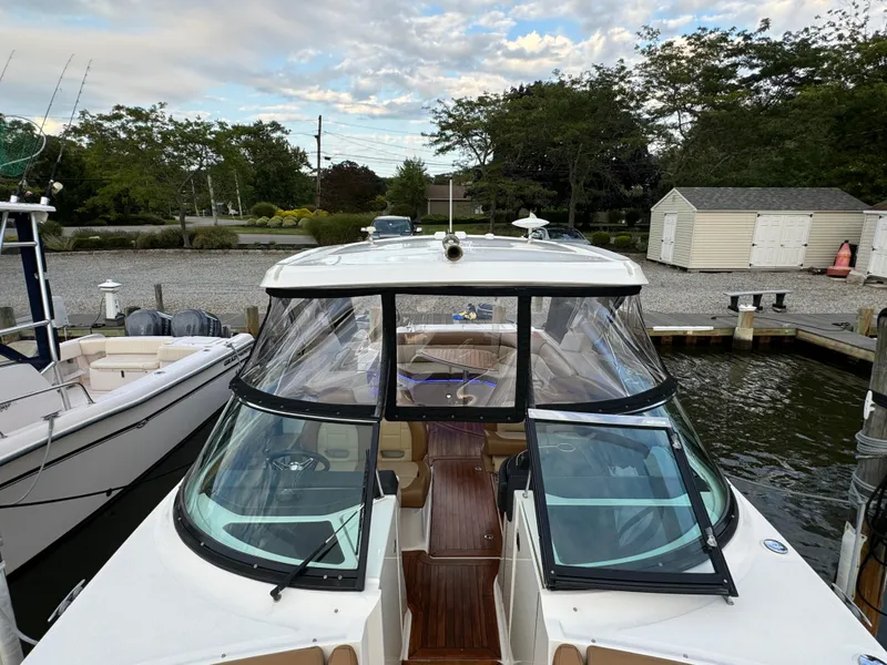Slide: The Image of 2015 Sea Ray 350 SLX boat docked at marina with clear skies. - 33