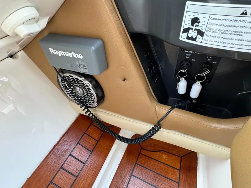 Slide: The Image of 2015 Sea Ray 350 SLX interior with Raymarine equipment and wood flooring. - 43