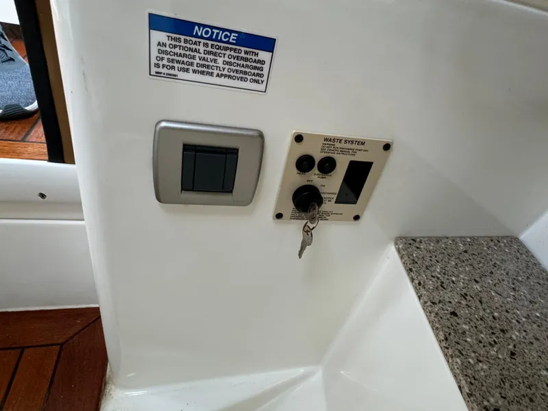 Slide: The Image of Control panel on 2015 Sea Ray 350 SLX boat with waste system notice. - 36