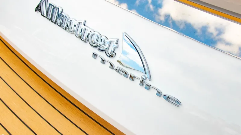 Slide: The Image of Alfastreet 21 Open 2023 model logo on white boat with wooden deck. - 37