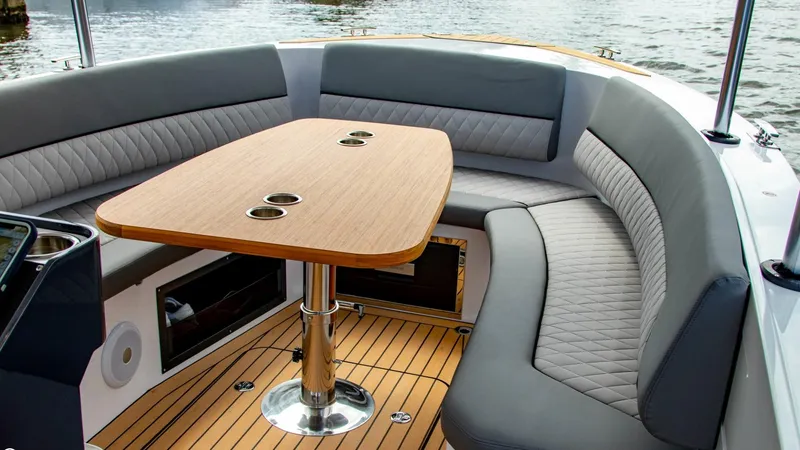 Slide: The Image of 2023 Alfastreet 21 Open boat interior with cushioned seating and wooden table. - 19