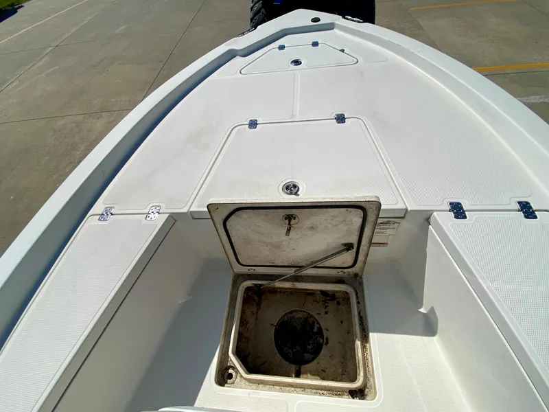 Slide: The Image of 2017 Mako 19 CPX boat deck with open storage compartment. - 14