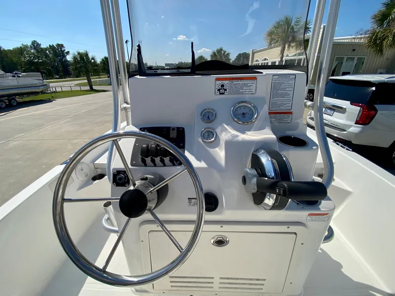 Slide: The Image of 2017 Mako 19 CPX boat console with steering wheel and controls. - 9