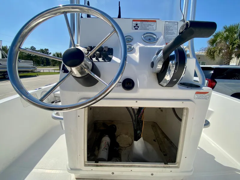 Slide: The Image of 2017 Mako 19 CPX boat console with steering wheel and control panel. - 10