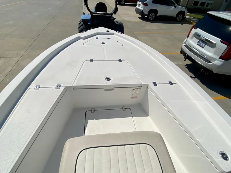 Slide: The Image of 2017 Mako 19 CPX boat bow with storage compartments and seating. - 12