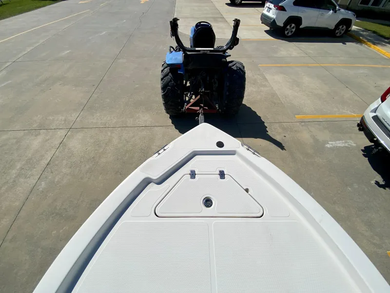 Slide: The Image of 2017 Mako 19 CPX boat being towed by a tractor in a parking lot. - 15