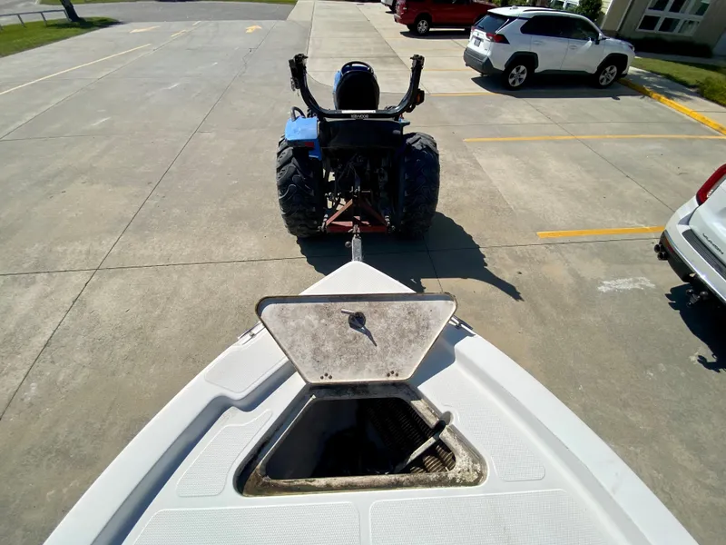 Slide: The Image of 2017 Mako 19 CPX boat being towed by a tractor in a parking lot. - 17