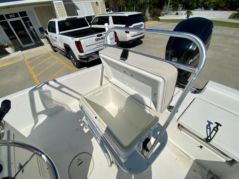 Slide: The Image of 2017 Mako 19 CPX boat with open storage compartment and Mercury outboard motor. - 8