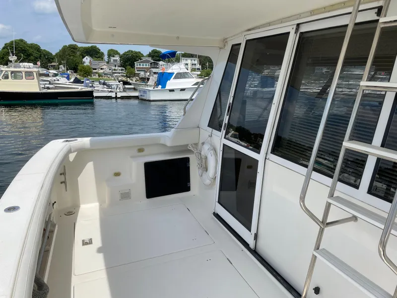 Slide: The Image of 1998 Bayliner 4788 Pilot House Motoryacht deck with marina view. - 12