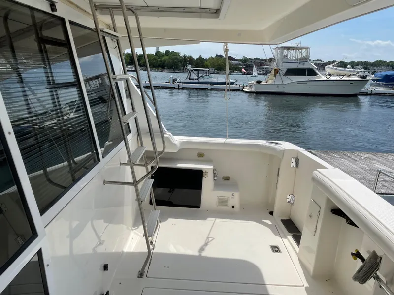 Slide: The Image of 1998 Bayliner 4788 Pilot House Motoryacht deck with marina view. - 13