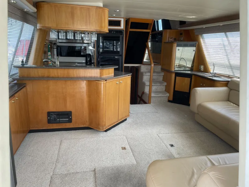 Slide: The Image of Interior of a 1998 Bayliner 4788 Pilot House Motoryacht with wood cabinetry and beige seating. - 15