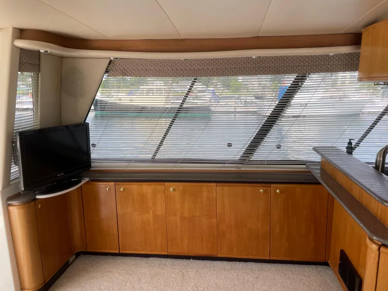 Slide: The Image of Interior of 1998 Bayliner 4788 Pilot House Motoryacht with TV and wooden cabinets. - 18