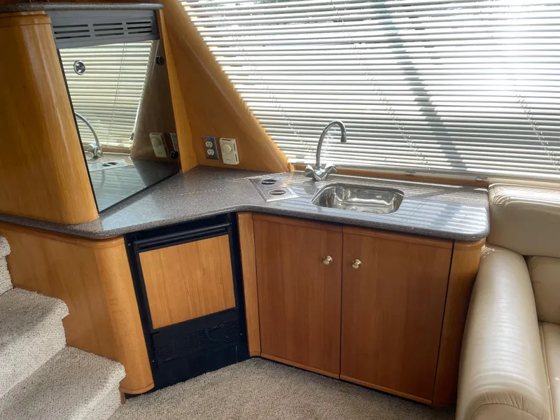 Slide: The Image of 1998 Bayliner 4788 Pilot House Motoryacht interior kitchen with sink and cabinets. - 19