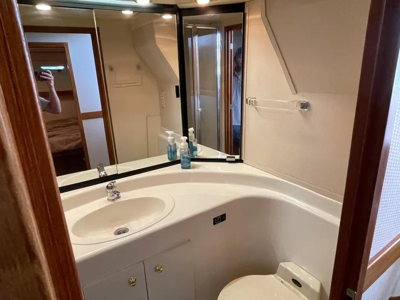 Slide: The Image of 1998 Bayliner 4788 Pilot House Motoryacht bathroom with sink, mirror, and toilet. - 27