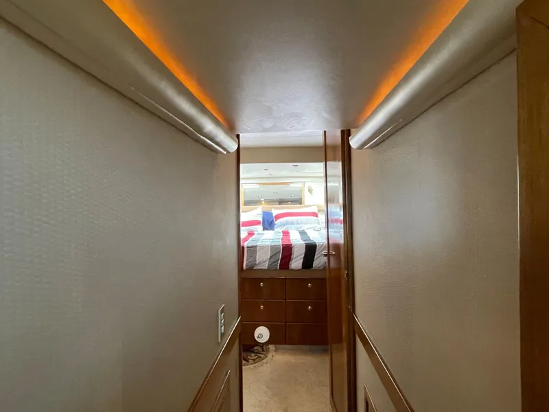 Slide: The Image of Narrow hallway leading to a cozy bedroom in a 1998 Bayliner 4788 Pilot House Motoryacht. - 31