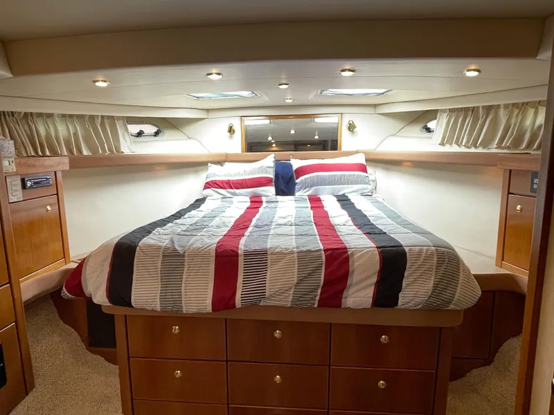 Slide: The Image of Luxurious bedroom in 1998 Bayliner 4788 Pilot House Motoryacht with striped bedding. - 32