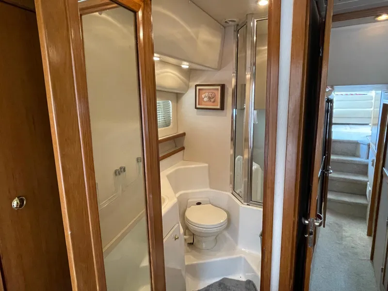 Slide: The Image of 1998 Bayliner 4788 Pilot House Motoryacht bathroom with shower and wooden accents. - 35