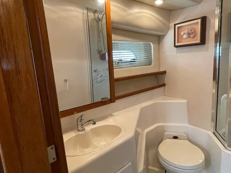 Slide: The Image of 1998 Bayliner 4788 Pilot House Motoryacht bathroom with sink, toilet, and shower. - 36