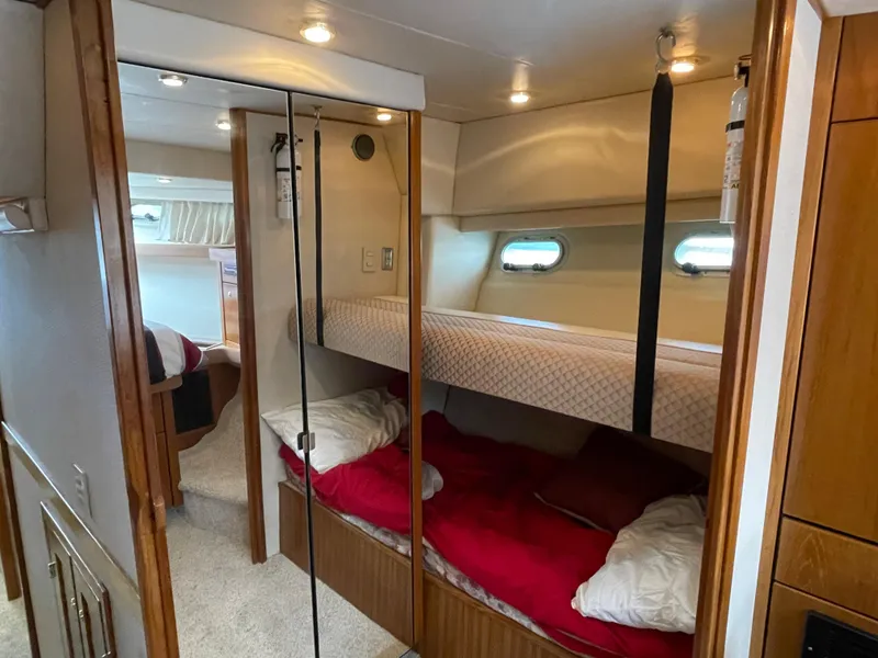 Slide: The Image of 1998 Bayliner 4788 Pilot House Motoryacht interior with bunk beds and cozy cabin. - 38