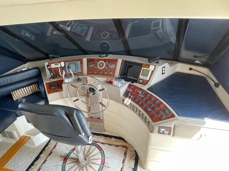 Slide: The Image of 1998 Bayliner 4788 Pilot House Motoryacht helm with navigation instruments and captain's chair. - 41