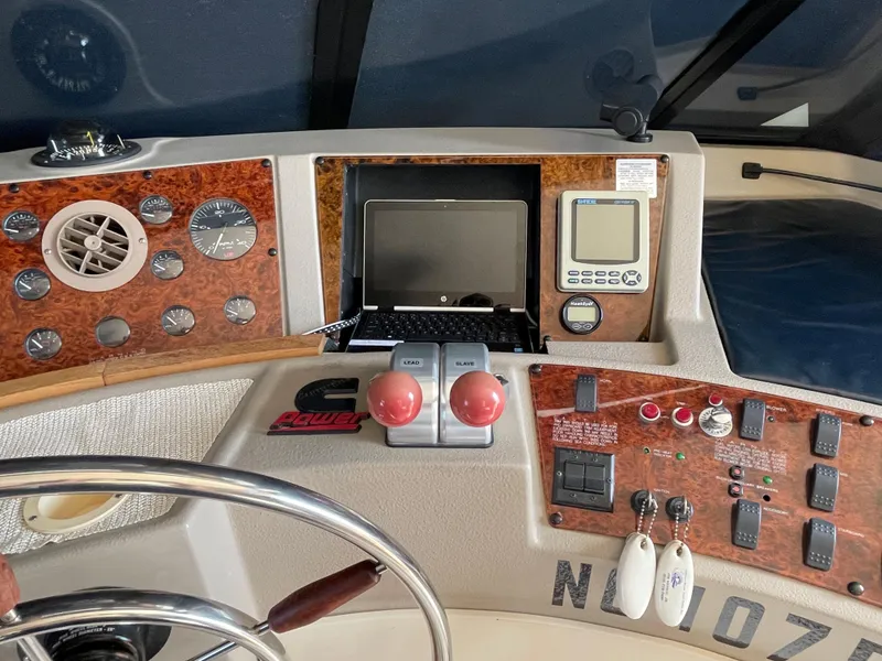 Slide: The Image of 1998 Bayliner 4788 Pilot House Motoryacht helm with navigation controls and instruments. - 45