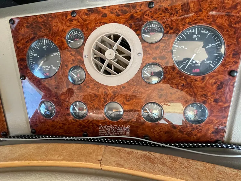 Slide: The Image of Dashboard of a 1998 Bayliner 4788 Pilot House Motoryacht with gauges and air vent. - 47