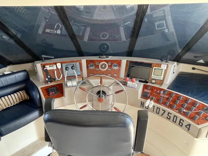 Slide: The Image of 1998 Bayliner 4788 Pilot House Motoryacht helm with navigation instruments and captain's chair. - 49