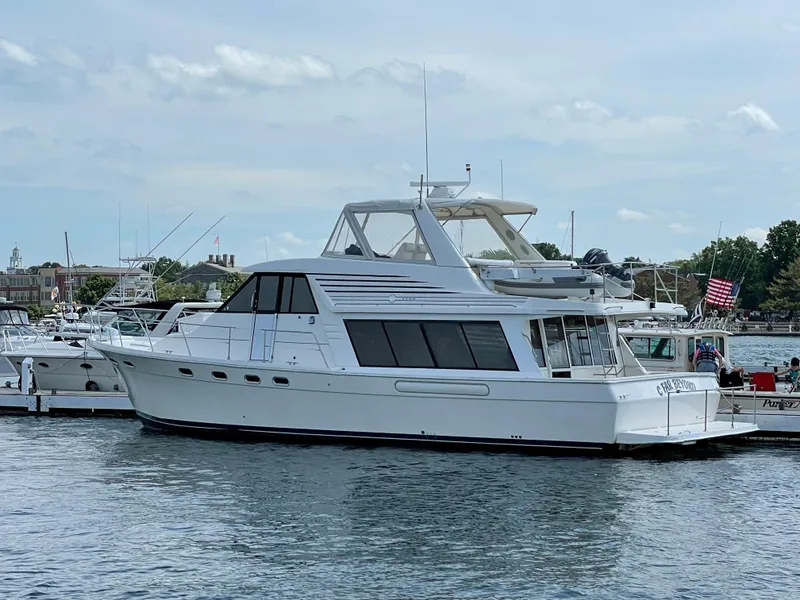 Slide: The Image of 1998 Bayliner 4788 Pilot House Motoryacht docked at marina. - 7