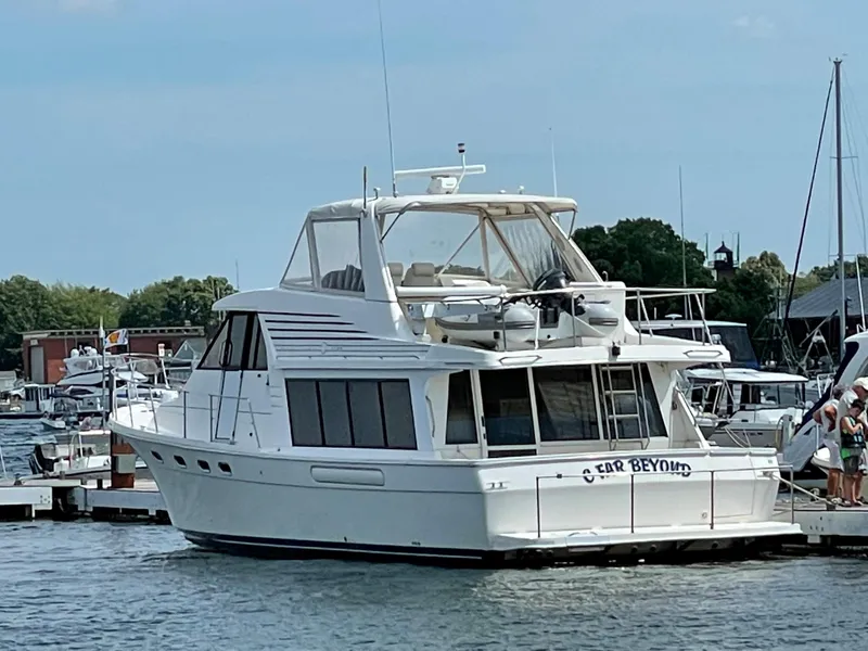 Slide: The Image of 1998 Bayliner 4788 Pilot House Motoryacht docked at a marina. - 9