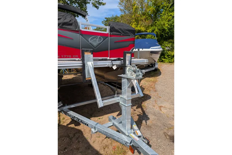 Slide: The Image of 2023 Avalon VENTURE CRUISE boat on trailer, parked outdoors. - 2