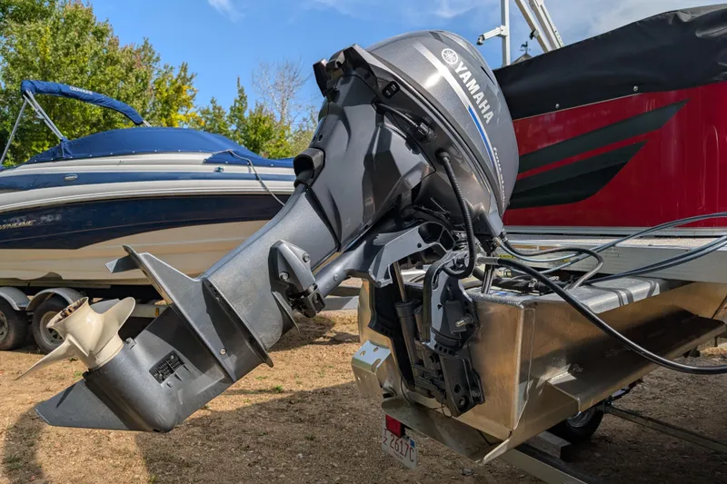 Slide: The Image of 2023 Avalon VENTURE CRUISE with Yamaha outboard motor, parked on a trailer. - 3