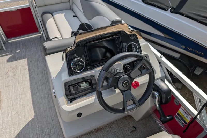 Slide: The Image of 2023 Avalon VENTURE CRUISE boat dashboard with steering wheel and control panel. - 9