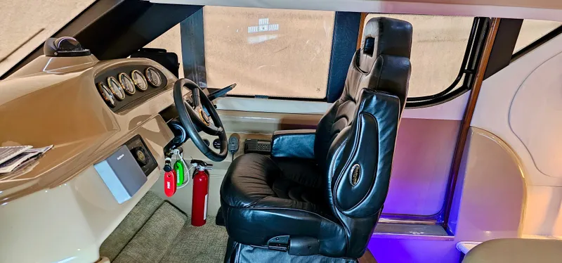 Slide: The Image of 1999 Carver 450 Pilothouse interior with captain's chair and control panel. - 25