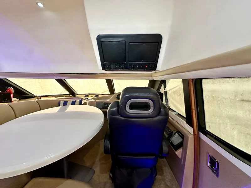 Slide: The Image of 1999 Carver 450 Pilothouse interior with captain's chair and dining table. - 27