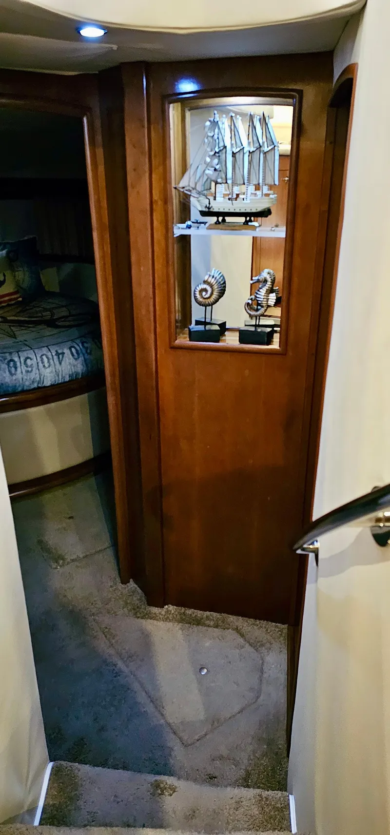 Slide: The Image of Interior of a 1999 Carver 450 Pilothouse yacht with wooden door and nautical decor. - 36