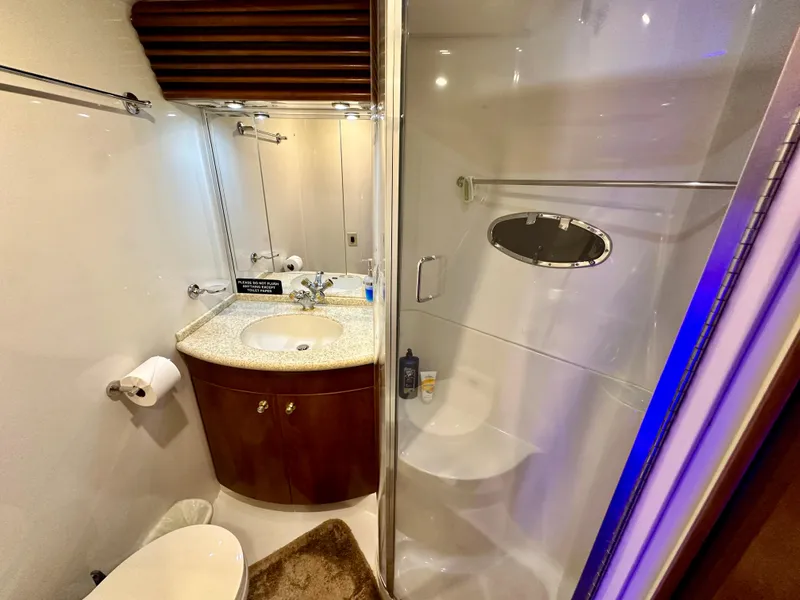 Slide: The Image of 1999 Carver 450 Pilothouse bathroom with sink, toilet, and shower. - 41
