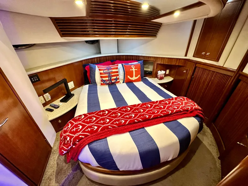 Slide: The Image of Cozy bedroom in a 1999 Carver 450 Pilothouse yacht with nautical-themed decor. - 43