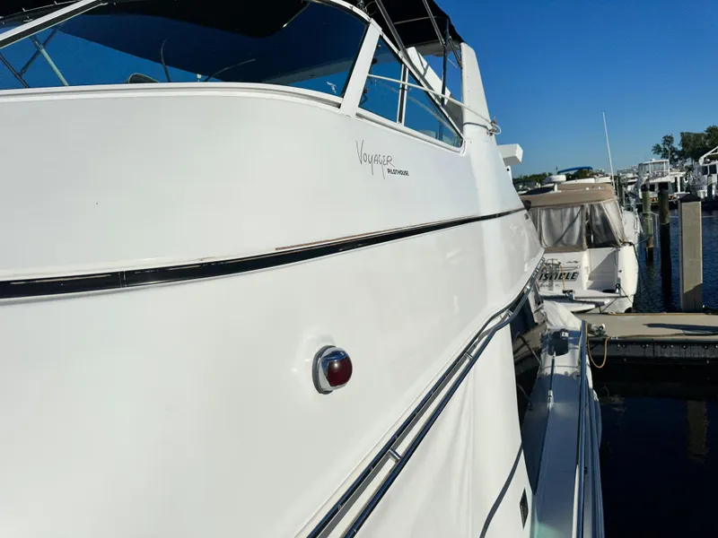 Slide: The Image of 1999 Carver 450 Pilothouse yacht docked at a marina. - 10