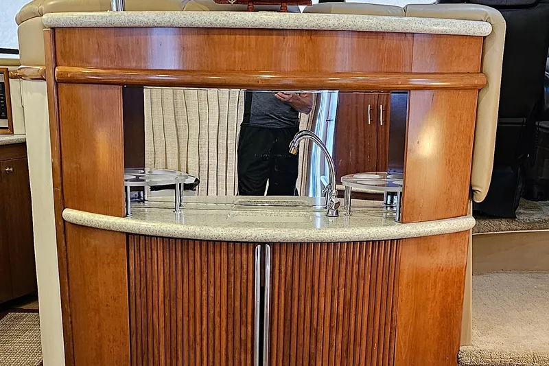 Slide: The Image of 1999 Carver 450 Pilothouse interior with wooden cabinetry and sink. - 18