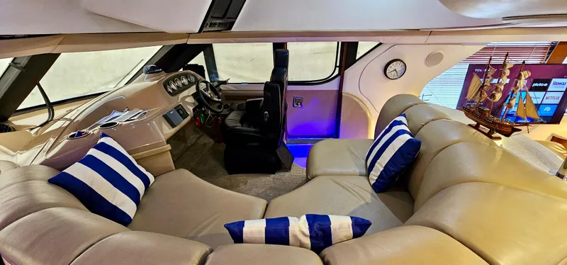 Slide: The Image of 1999 Carver 450 Pilothouse interior with leather seating and nautical decor. - 30