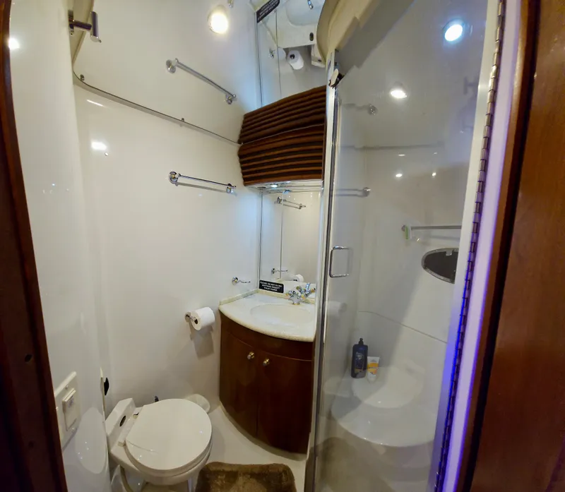 Slide: The Image of 1999 Carver 450 Pilothouse bathroom with shower, toilet, and sink. - 45