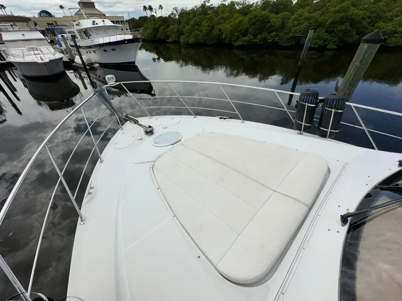 Slide: The Image of 1999 Carver 450 Pilothouse yacht docked at a marina. - 8