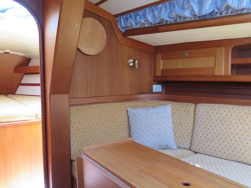 Slide: The Image of Interior of 2002 Arcona 355 Sloop with wooden furnishings and cozy seating area. - 15