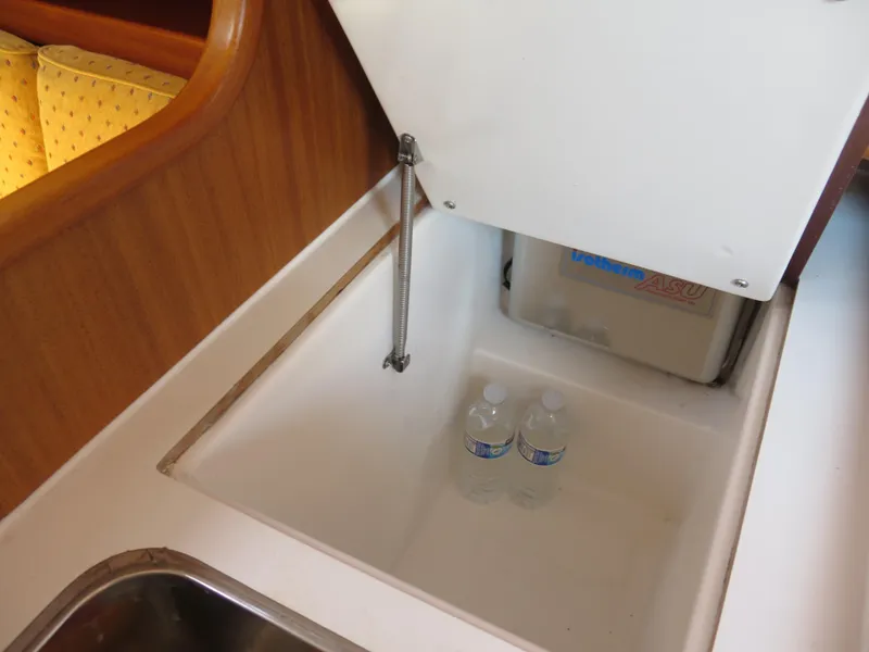 Slide: The Image of Storage compartment with water bottles in 2002 Arcona 355 Sloop sailboat. - 16